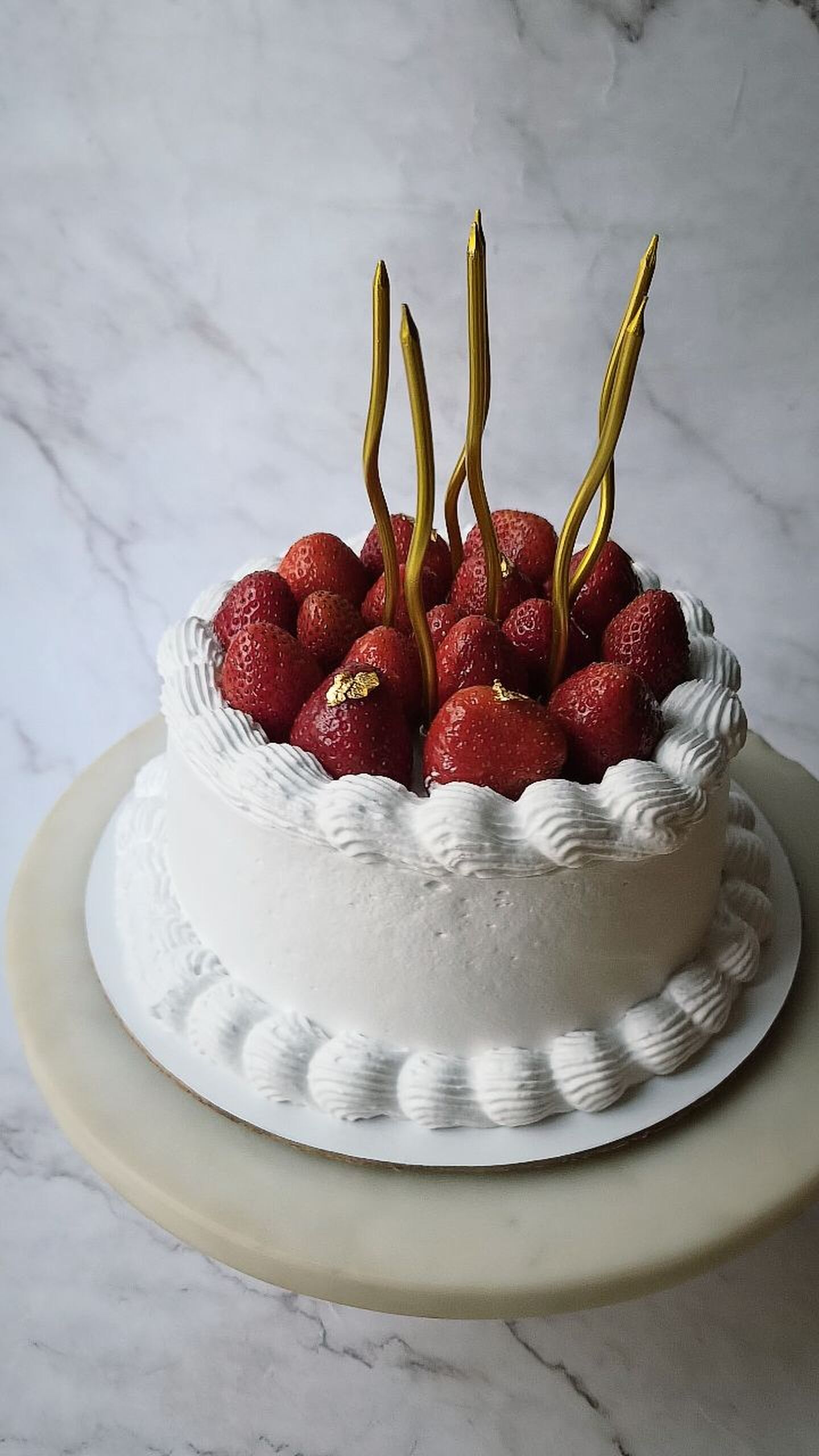Fresh berries and cream swirls on a vintage celebration cake